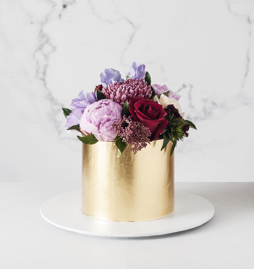 Blueberry Moon Cakes: a photo of a small gold flower wedding cake. www.blueberrymooncakes.co.uk. Bristol, UK